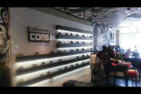 Immediately inside the store there is a large workshop area where shoppers can have their purchases personalised with notices urging shoppers to “Customize your Converse in 3 steps” alongside “Converse blank canvas”.